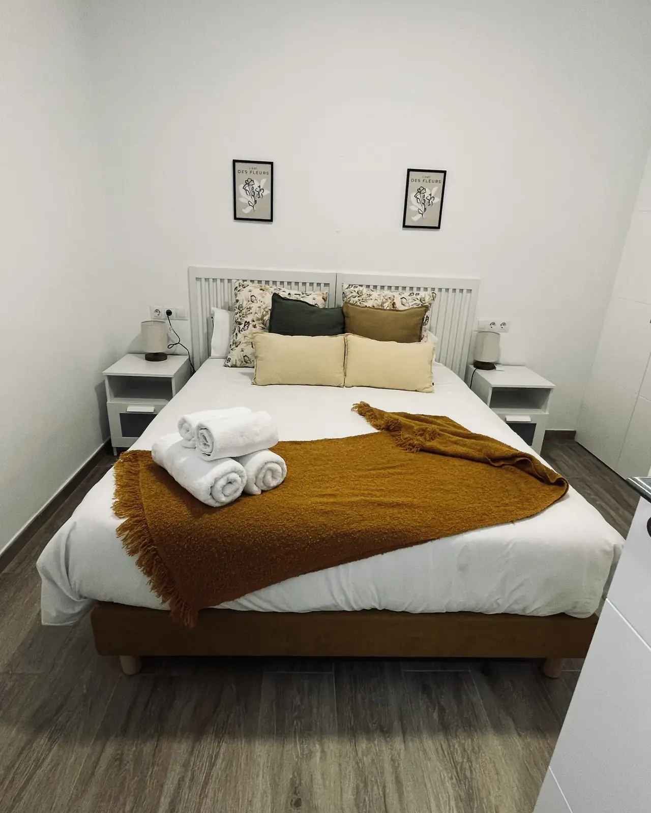 Cama hecha con ropa limpia y toallas dobladas en un apartamento turístico de Campo Mijas (Mijas)